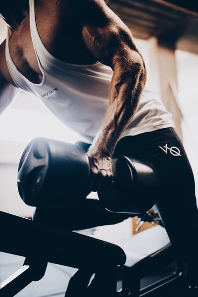 A blue vest and black shorts with a black man of dumbbell
